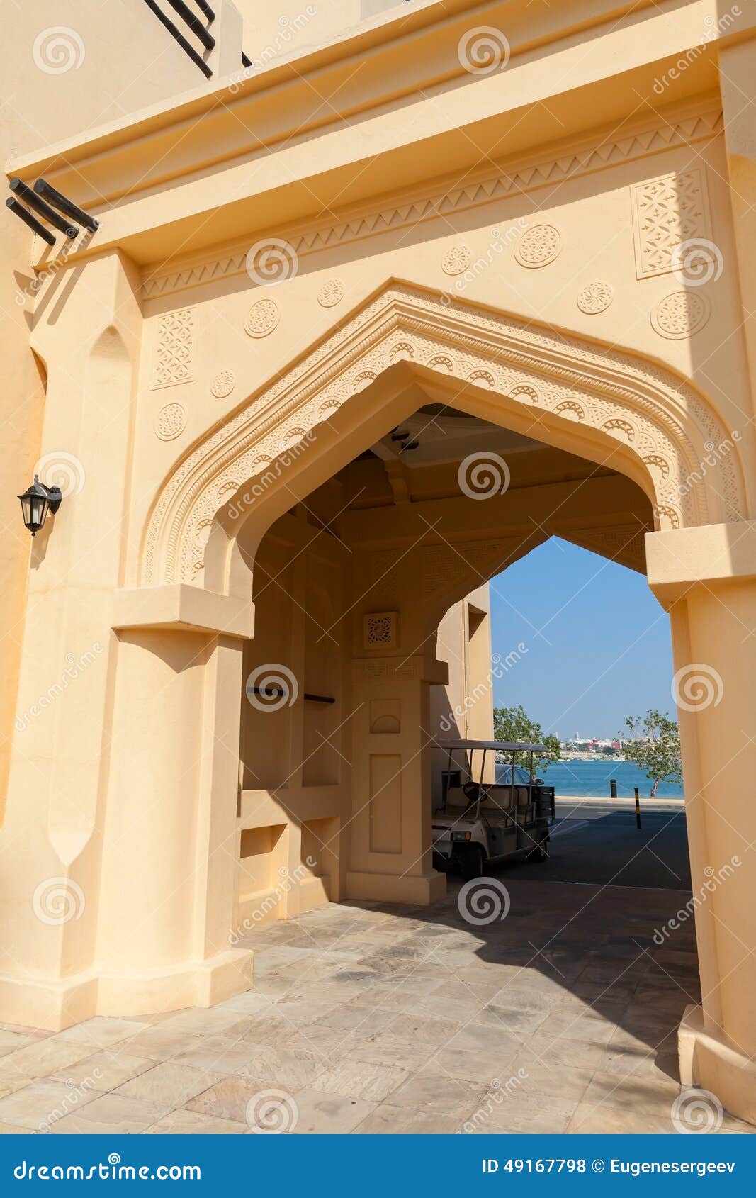 yellow-house-facade-classical-arabic-arch-style-49167798.jpg