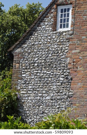 stock-photo-flint-stone-and-brick-wall-to-old-house-in-worthing-west-sussex-england-59809093.jpg